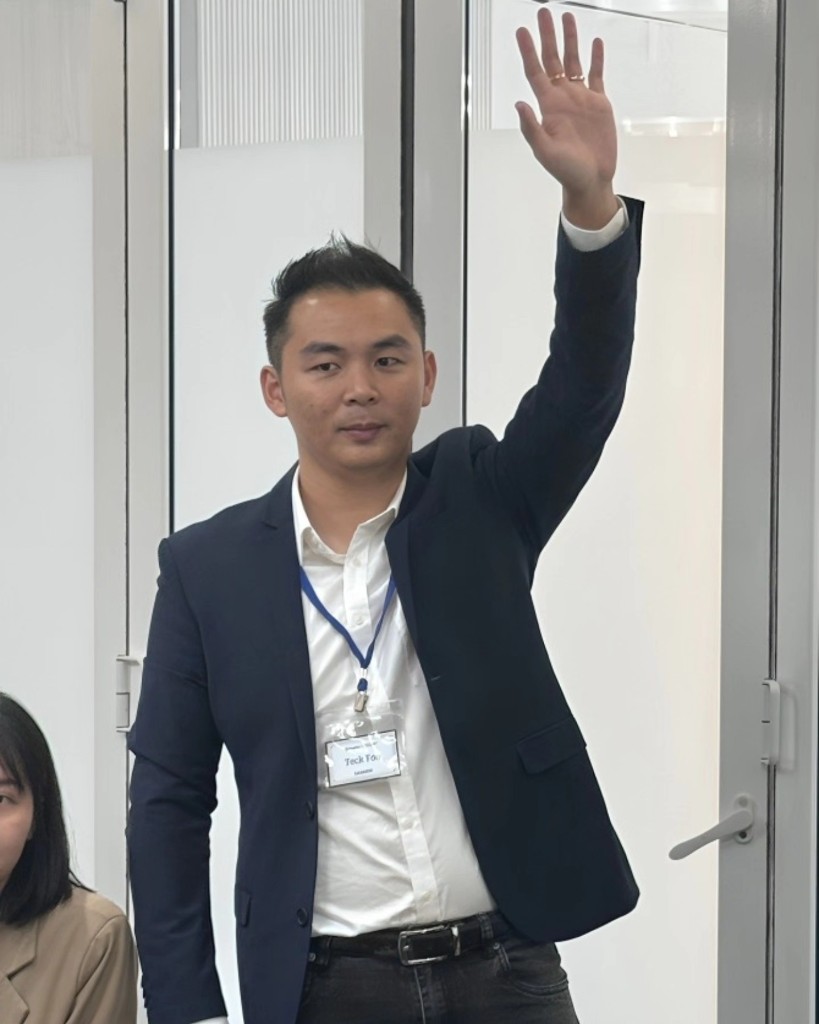 Participant raising hand to speak in training session